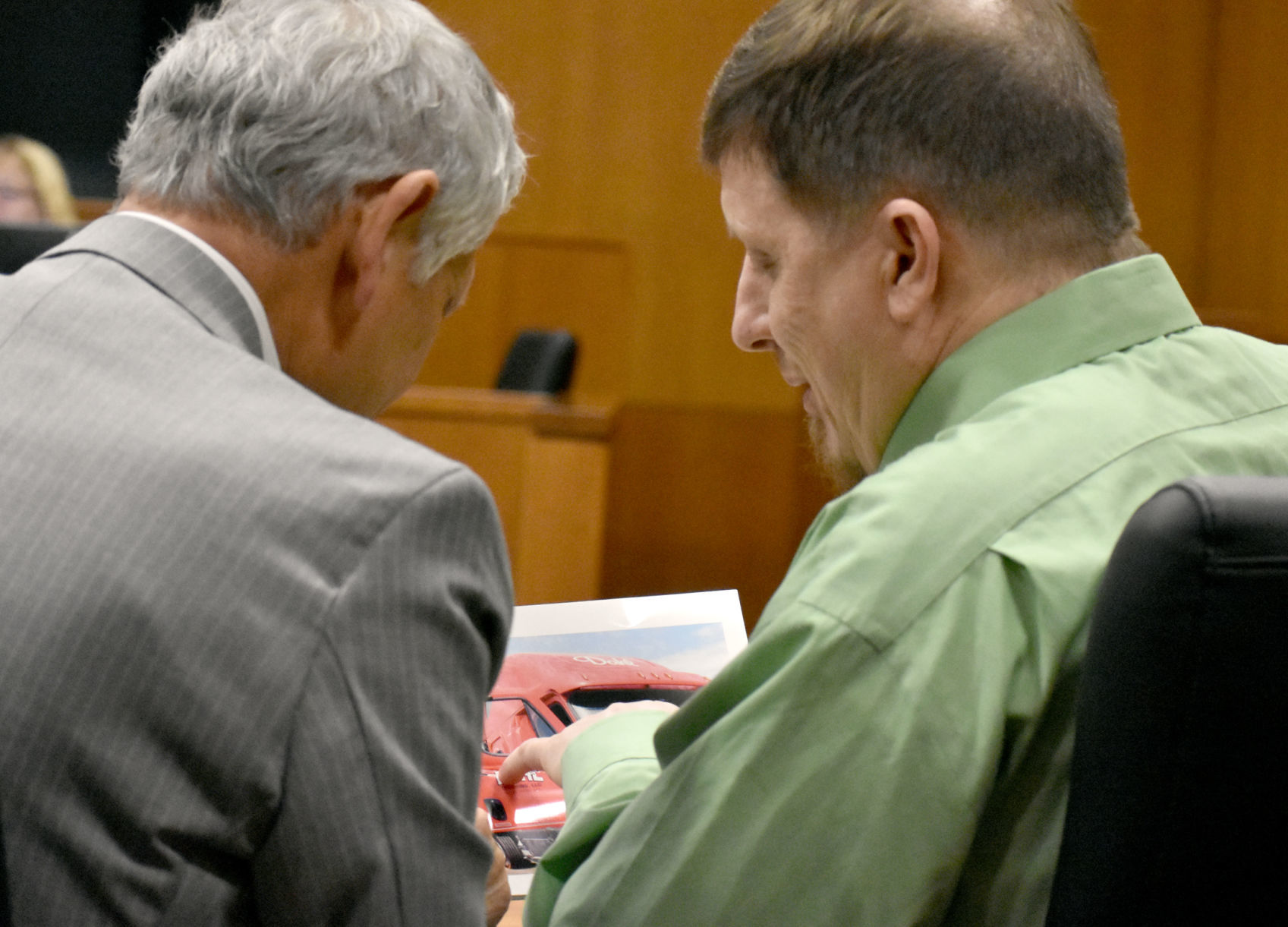Wayne Murphy shows photo to attorney